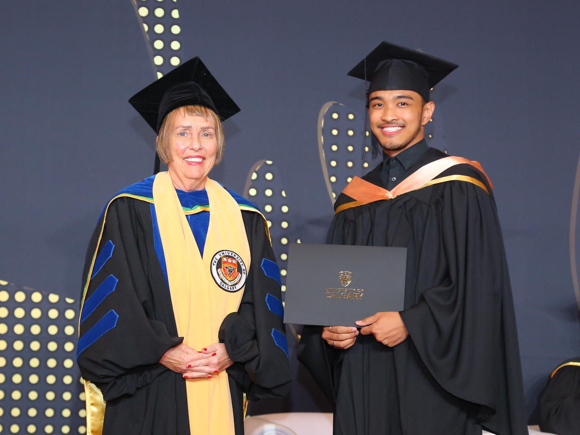 Dr Deborah White handing over degree to 2022 graduate